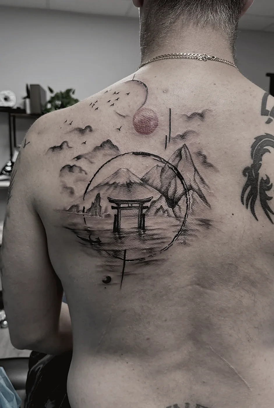 Japanese-style back piece tattoo in black and grey