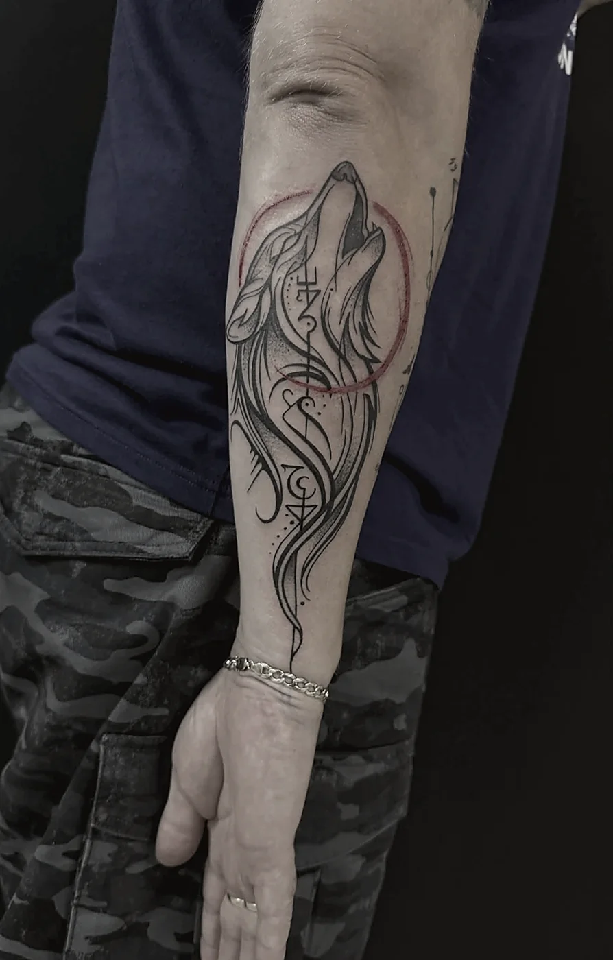 Sketch-style wolf tattoo in black and grey
